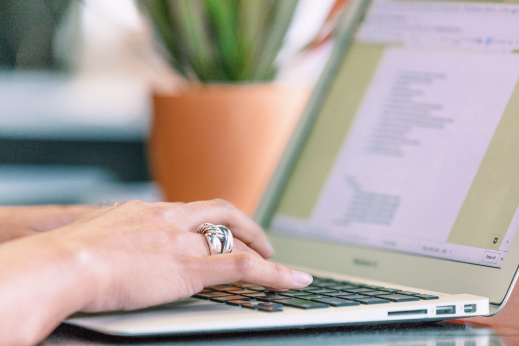 Person using a laptop for business and agency work